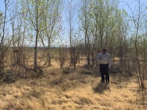 Joe from USFWS standing by trees, June 2021